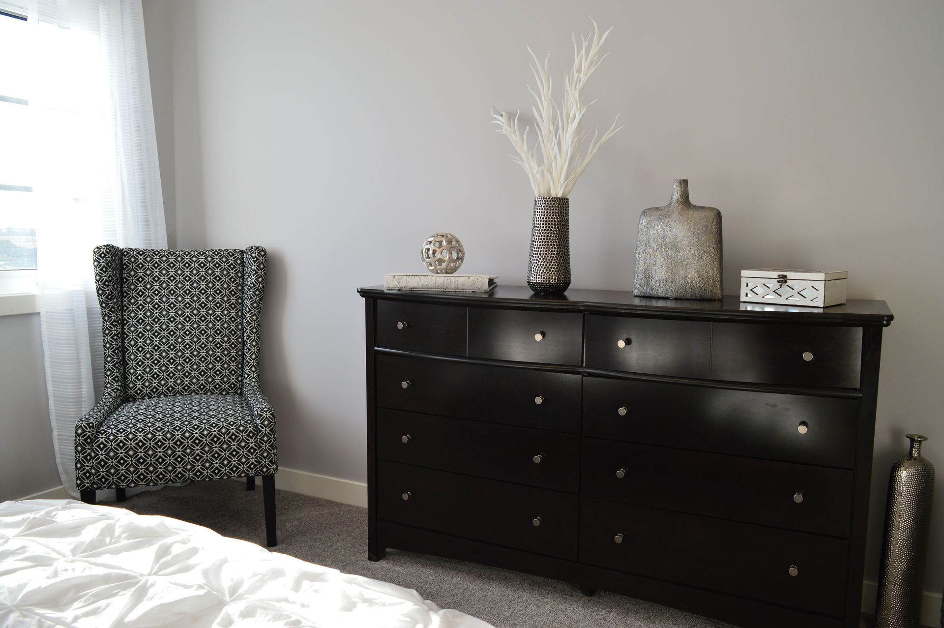 Sleek and stylish bedroom with modern black furniture and elegant decor.