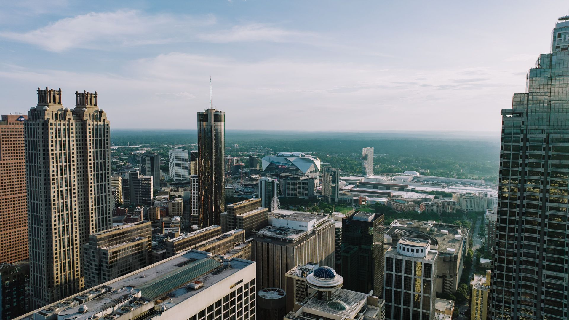 Breathtaking aerial view of Atlanta's skyline showcasing iconic buildings under a clear sky.