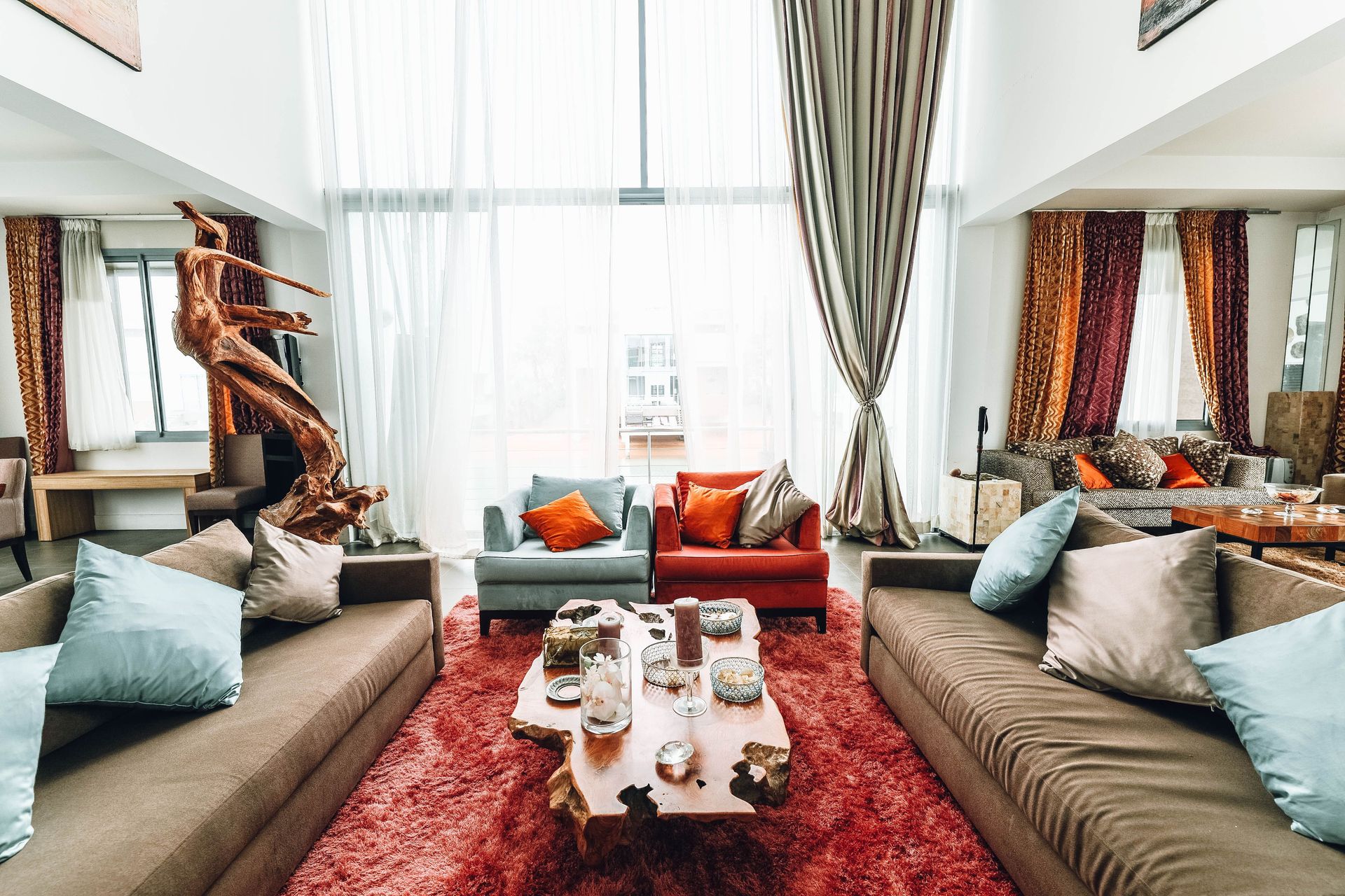 A spacious, luxurious living room with modern furnishings and natural wood decor.
